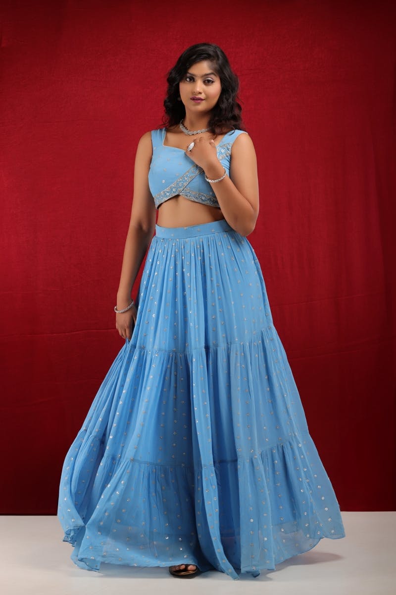 Sky blue georgette overlapping blouse with silver kadadana embroidery and 3 layer tiered lehenga set